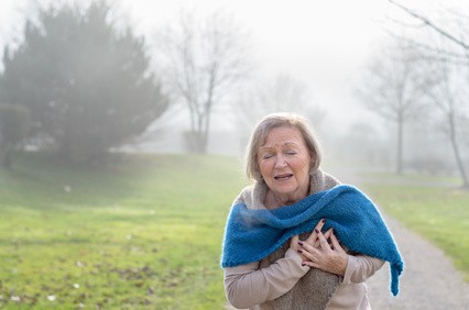 Senior lady clutching her chest in pain